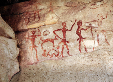 Cave art work on a rock with red paintings Cave art example